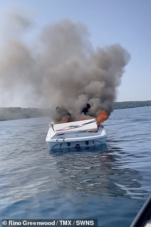It’s gonna blow!’ Shocking moment two boaters leap into the water off the coast of Michigan as vessel erupts in flames Two people were trapped on board a 21-foot Baja as it went caught fire on West Grand Traverse Bay.