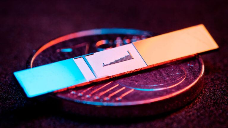 An image of a miniature accelerator clip sitting on top of a 1 euro cent coin.