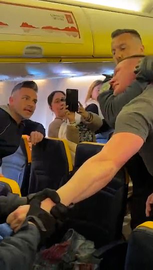 Shocking moment Ryanair holidaymaker is dragged off the flight in a headlock by police after UK-Lanzarote flight had to divert to Portugal ‘after rowdy group knocked over a steward’ This is the shocking moment a holidaymaker was grappled into a headlock and violently marched off a Ryanair flight by police after a Luton to Lanzarote flight was diverted to Portugal because of his behaviour
