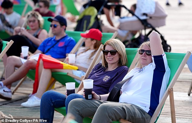 Here we go! Pubs get the OK to stay open to 1am for Euros 2024 final as England bid for glory – with fan excitement building already in Germany, UK and even Benidorm Fans sit on deck chairs with drinks in the Euro Fan Zone near Brandenburg Gate in Berlin