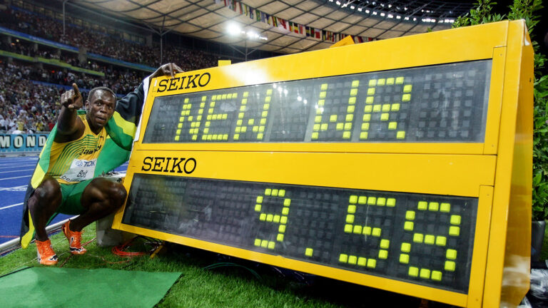 How much more can Olympic speed records fall? Usain Bolt crouches next to a digital display showing his new world record while pointing to a crowd in a stadium