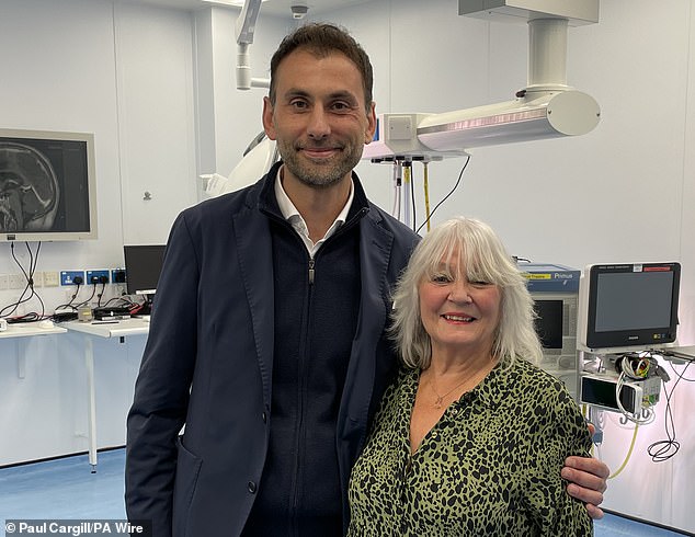 World first: British surgeon removes ‘tennis ball-sized’ brain tumour through patients’ eyebrow Consultant neurosurgeon Anastasios Giamouriadis of NHS Grampian, Scotland, pictured with 75-year-old patient Doreen Adams, has adapted an existing technique of keyhole surgery that takes half the time to complete