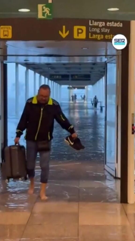 Barcelona is put on flooding red alert as flights are diverted and city airport is submerged in shocking new footage after Spain’s king and queen were pelted with mud while visiting devastated Valencia A man is seen taking his shoes off and wading through the departures hall at El Prat airport