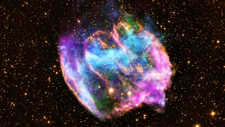 Let’s learn about supernovas A false-color image of a supernova remnant includes clouds of blue, green, pink and yellow against a backdrop of stars
