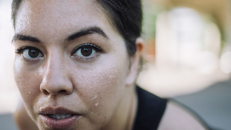 Forget droplets. Here’s how sweat really forms a close-up photo of a woman with with sweat droplets on her face