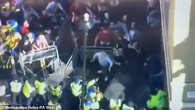 Tommy Robinson protesters hurl missiles at police before officers fight back and arrest nine as 110,000-strong ‘biggest ever’ anti-migrant demo takes over central London Overhead footage shared by the Met Police showed groups of protesters attempting to force their way through police barriers
